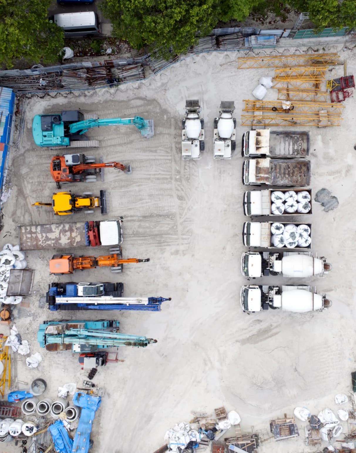 Aerial photograph of Rainbow Construction's yard: cranes, excavators, mixers and materials.